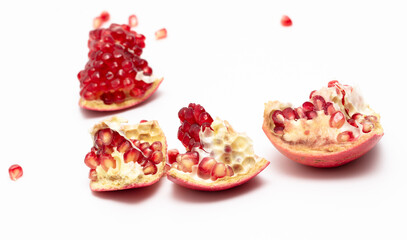 Juicy pomegranate berries isolated on white background.