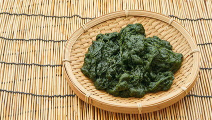 heap of Fresh Korean Seaweed Fulvescens or Maesaengi in wood plate on wooden table or bamboo mat background. Seaweed Fulvescens