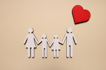 Figures of family and heart on beige background, top view. Insurance concept