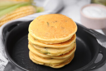 Tasty corn pancakes served on table, closeup