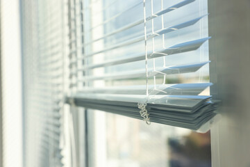 Stylish window with horizontal blinds indoors, closeup. Space for text