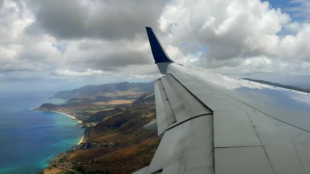 View from an airplane window of the wing and the landing to Hawaii big island