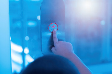 Hand pressing elevator button.