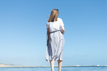 Fototapeta na wymiar woman standing on the beach