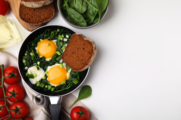 Flat lay composition with tasty green Shakshouka and ingredients on white table. Space for text