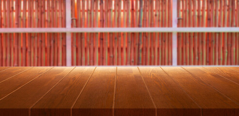 blurred bamboo sticks background over wooden board