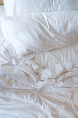 Fototapeta na wymiar white pillows on crumpled bed
