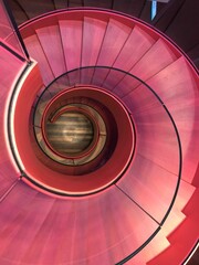 High angle shot of a pink spiral staircase