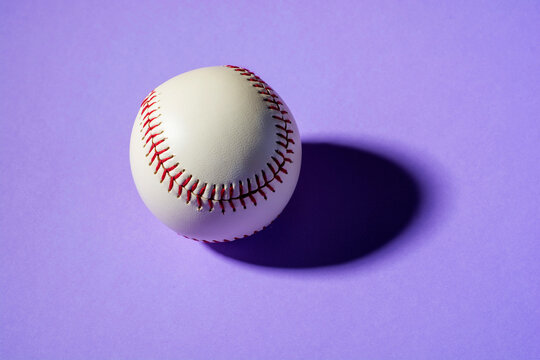 baseball ball on violet background close up with shadow