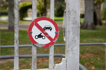 motorcycle and car prohibited traffic road sign No motorbike auto no parking panel red white front gate street