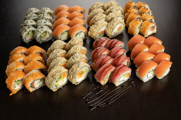 Big Sushi set with fresh ingredients on black background. Sushi menu. Japanese food