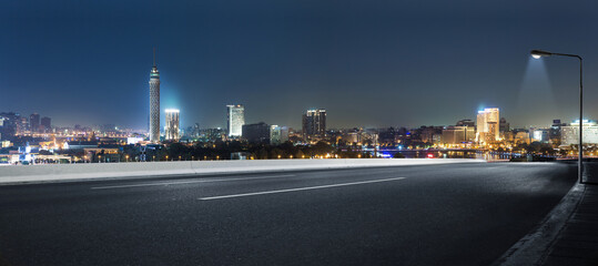 Cairo street at night in Egypt - road in Cairo city with buildings and Cairo tower in Background -  - Powered by Adobe