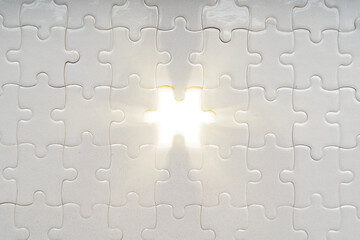 Solution concept. soft sun light ray coming through under a missing piece of jigsaw puzzle