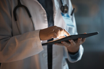 Doctor hands, tablet and night research in hospital office for online consultation or telehealth...