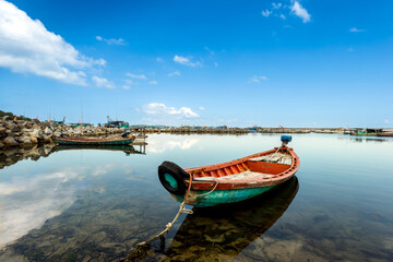 Obraz premium A wooden fishing boat is anchored in the pier in Phu Quoc Island, Vietnam.