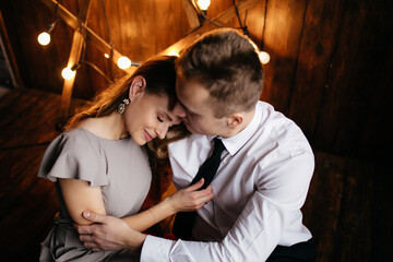 Happy smiling family at  studio on background of the Christmas tree with gift