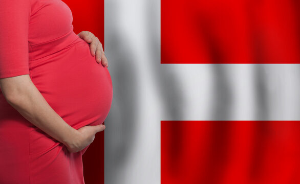 Pregnant woman belly on Danish flag background