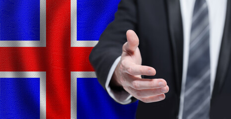 Icelandic business, politics, cooperation and travel concept. Hand on flag of Iceland background.