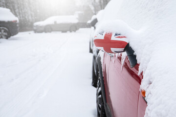 Snowy parking lot. Snowfall and storm. British flag