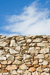 Stone wall with large stone blocks against a sky background