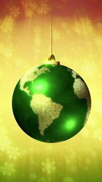 Christmas background loop. The Earth as a rotating Xmas ball. Green and gold bauble on a background of snowflakes falling. Vertical format.