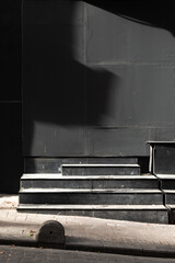 Black wall with the steps in front.