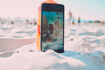 Phone, sand and friends taking a picture on the beach while on a summer vacation together. Travel,...