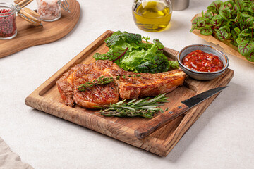 Portion of gourmet beef tomahawk steak with salad and sauce