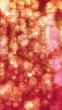 Christmas and celebration background loop. Defocused snow or glitter. Red and gold sparkly hexagons. Vertical format.