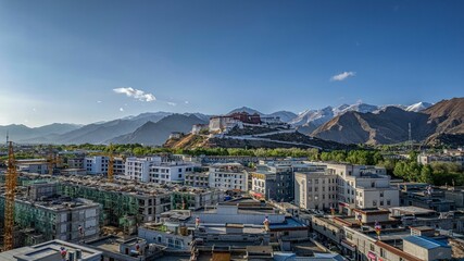 Ancient Potala Palace on a hill from the buildings in Lhasa, Tibet,China - obrazy, fototapety, plakaty