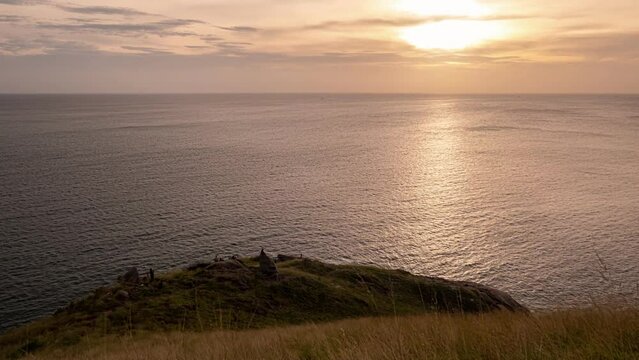 Sunset over tropical sea and meadow in Laem Krating at Phuket