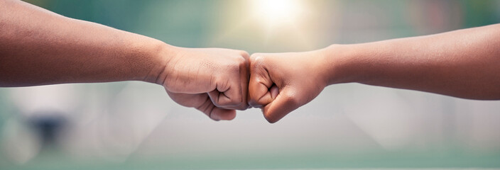 Closeup, fist bump and sport for success, motivation or teamwork together with lens flare while...