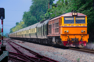 Fototapeta premium Passenger train by diesel locomotive on the railway.