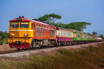 Fototapeta premium Passenger train by diesel locomotive on the railway.