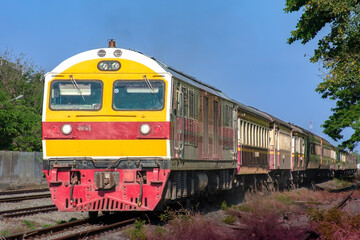 Fototapeta premium Passenger train by diesel locomotive on the railway.
