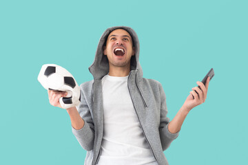 male football fan with a crumpled ball and smartphone