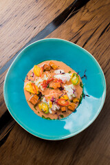 shrimp and crab meat in a plate with baked vegetables