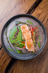 salmon, trout on a plate with vegetables and sauce
