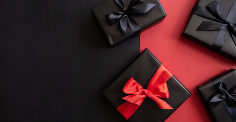 Gift box wrapped in black paper with a bow. Holiday concept. Place for text or advertising. Christmas. Valentine's Day.
