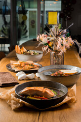 several dishes on the table, red fish and seafood