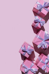 Gifts in modern, stylish boxes on a delicate pink background. Holiday concept, copy space. - obrazy, fototapety, plakaty