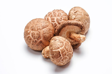 Dry shiitake mushrooms on white background close-up, side view.
