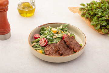 Portion of gourmet salad with roast beef