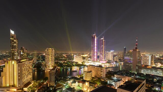 Annual celebration colorful light show on Chao Phraya riverside and landmark building in downtown at Bangkok