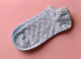 women's socks with polka dots on a pink background