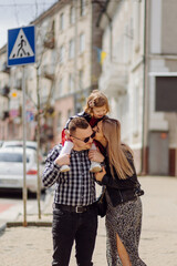 Parents and daughhter walking around the city. Spend time together. They are happy