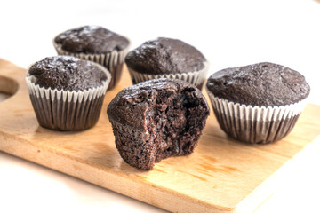 chocolate muffin on a wooden plank isolated on white background.dessert. food concept
