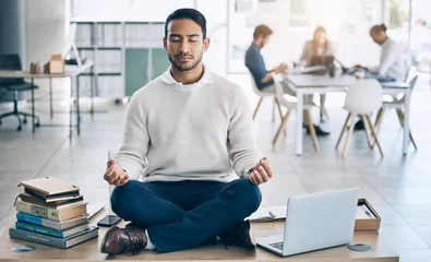  Meditation, relax or businessman with laptop, books or zen peace in office desk for work mindset, wellness or mental health. Corporate, employee or Asian man relaxing, meditating or lotus pose © Rene L/peopleimages.com