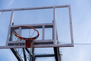 New basketball board with basket on blue sky background