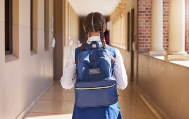 Girl student, backpack and walking in a school back for study, education and morning class. Young...
